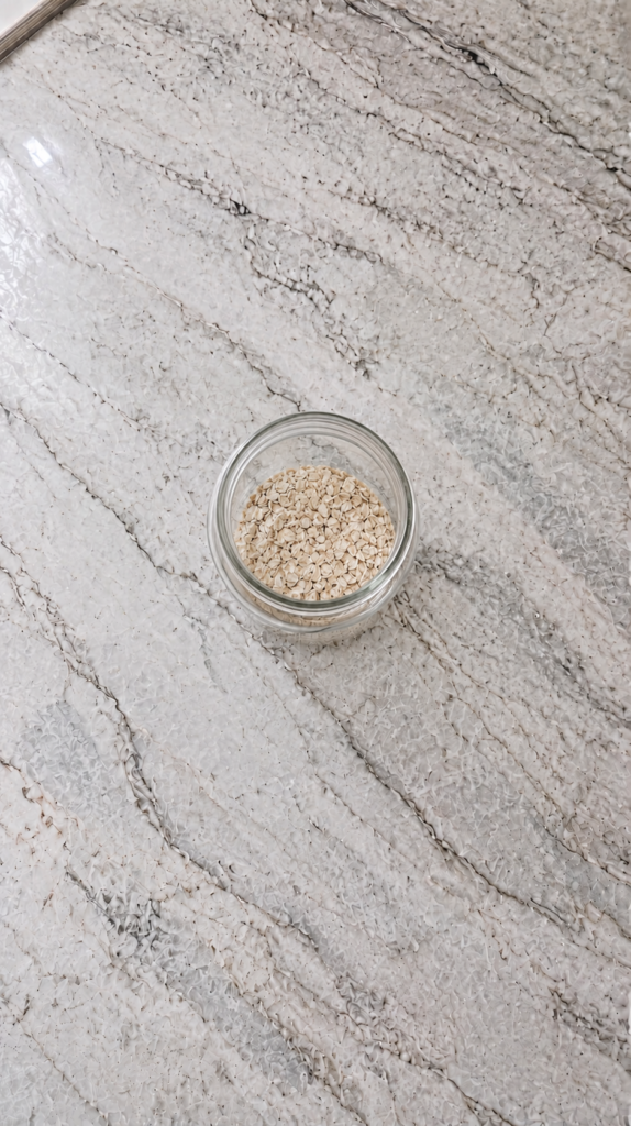 high protein overnight oats with fresh berries in glass jar on marble countertop