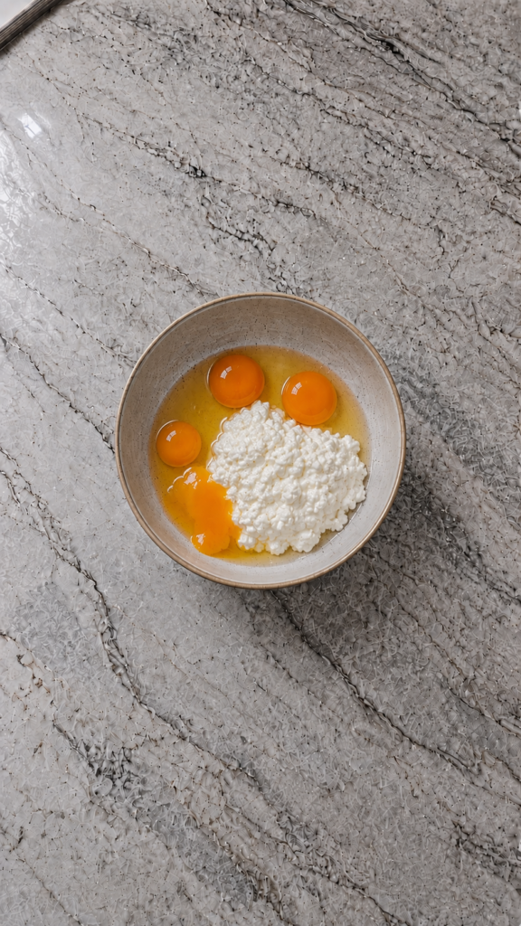 eggs and cottage cheese in bowl before mixing — high protein egg bites ingredients