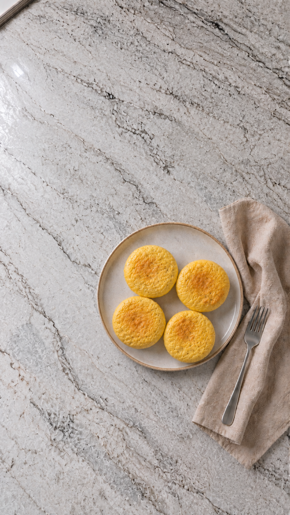 starbucks copycat high protein egg bites on a ceramic plate with fork and linen napkin on marble countertop