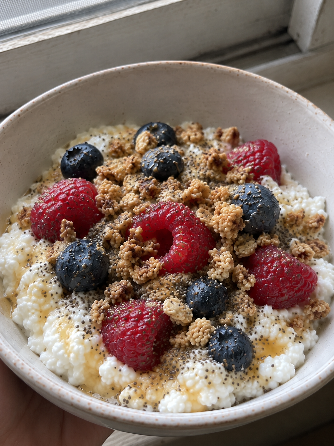 High Protein Cottage Cheese Bowl For Weight Loss high protein cottage cheese bowl with raspberries blueberries granola and chia seeds overhead shot