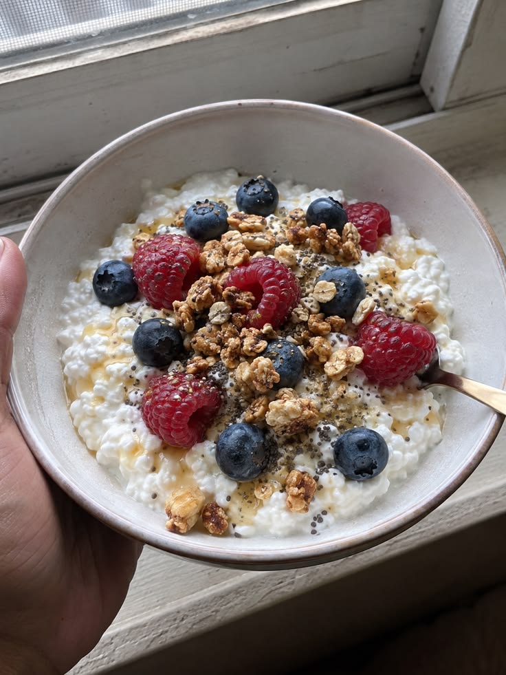 High Protein Cottage Cheese Bowl For Weight Loss high protein cottage cheese bowl with raspberries blueberries granola and chia seeds overhead shot